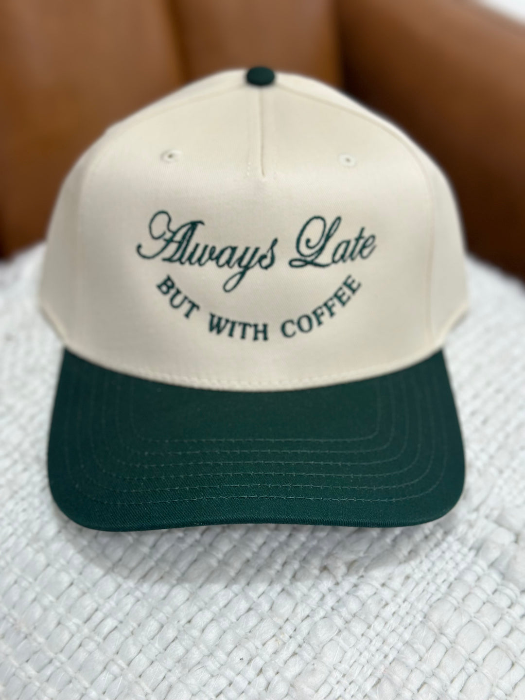 The Always Late But With Coffee Cap in hunter green and cream brings the humor and the caffeine vibes with bold embroidered text on a classic adjustable snapback. Featuring a structured front, breathable mesh back, and vintage-inspired color combo, it’s the perfect cap for fashionably late arrivals and coffee-fueled days.

