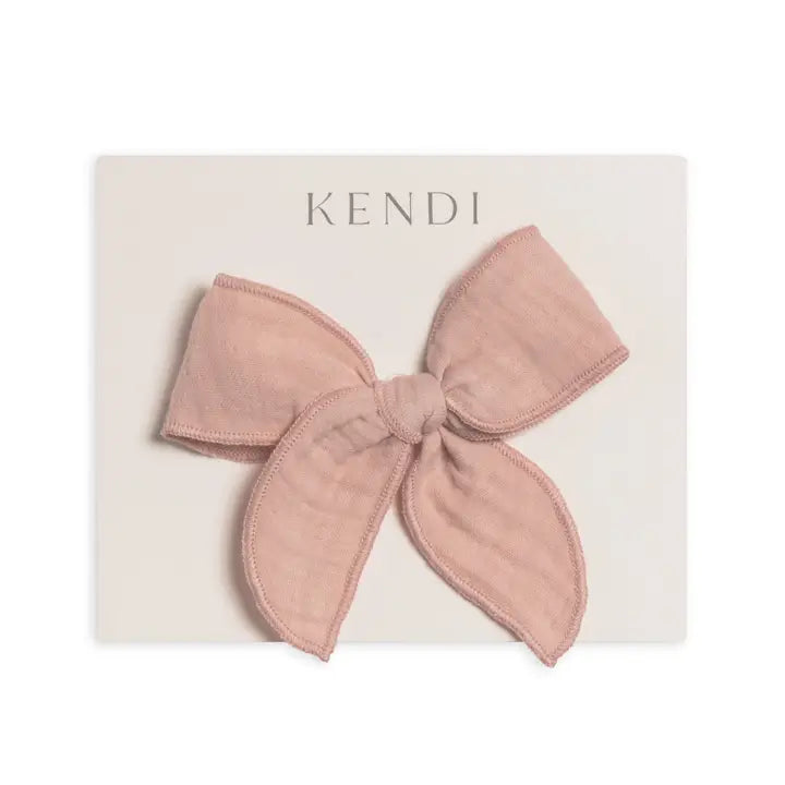 Ballet pink muslin bow hair clip for toddlers and young girls crafted from soft lightweight fabric gentle on hair ideal for styling, everyday wear, or special occasions a practical and adorable hair accessory that makes a thoughtful gift for children.