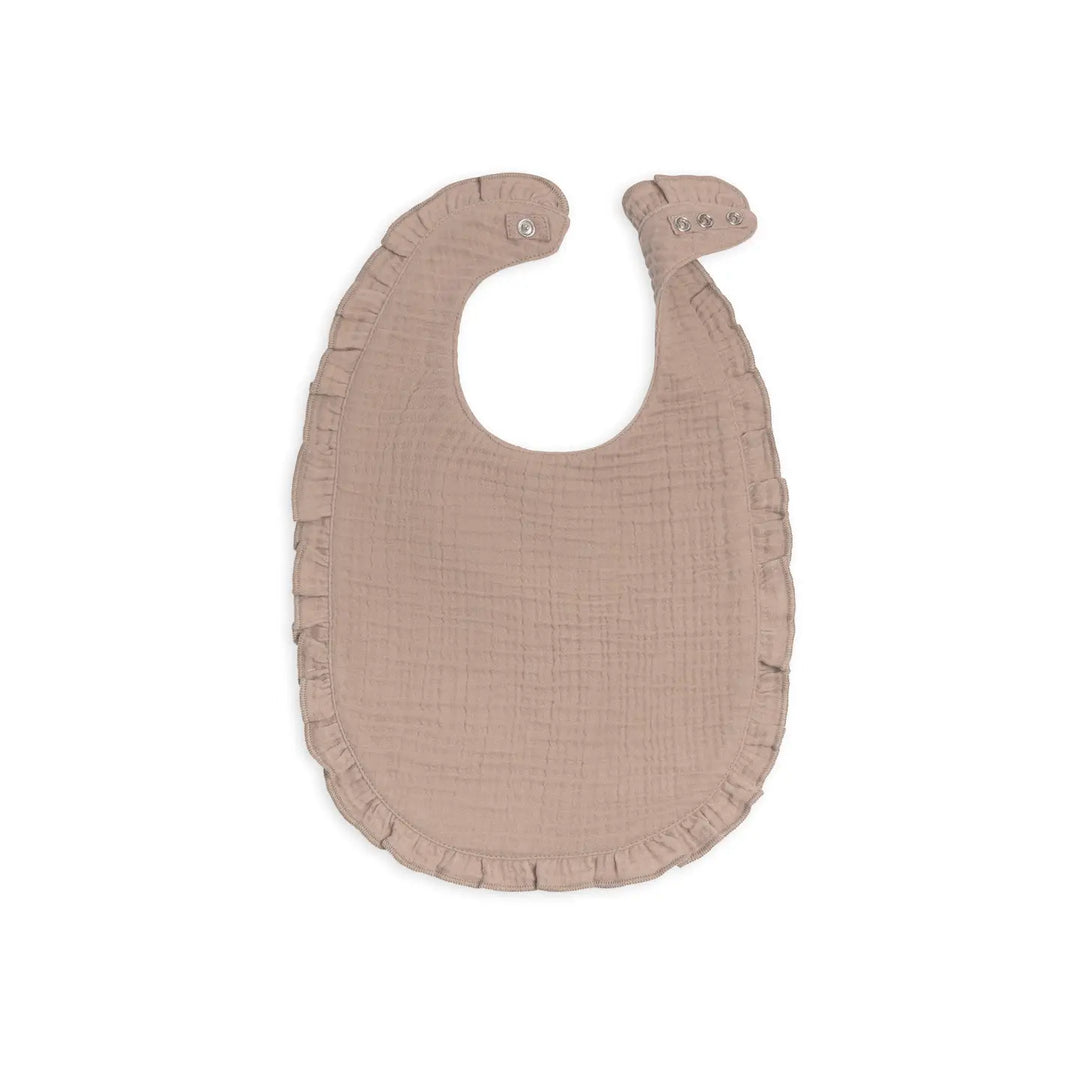 Beige organic muslin baby bib with ruffles made from soft and highly absorbent natural cotton fabric perfect for baby girls and boys this baby bib helps protect clothing during feeding time drooling or teething and is ideal for new moms looking for practical stylish and sustainable baby essentials this beige organic muslin bib makes a thoughtful baby shower gift for parents who value natural materials neutral colors and long lasting baby accessories that combine comfort function and organic quality
