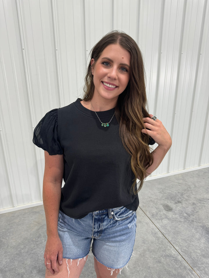 Discover elegance with The Windsor black puff sleeve top, designed with a blend of 95% cotton and 5% viscose for ultimate comfort. Suitable for various occasions, this top comes in sizes X-Small to Large, ensuring a chic fit for everyone.