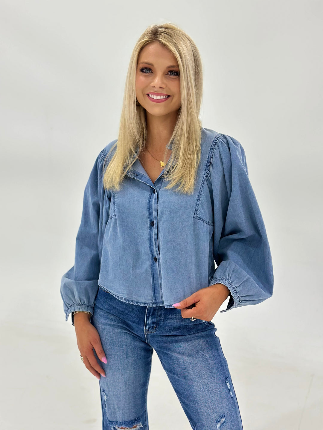 The Zara is a long sleeve women’s denim button down shirt featuring standout volume sleeves and a timeless silhouette with a modern twist. Made from structured yet breathable denim, this shirt is a versatile staple perfect for layering or wearing solo. The button front detail adds classic charm, while the voluminous sleeves give it that fashion-forward edge that sets it apart from basic denim tops. Whether styled open over a tank or buttoned up with boots, this shirt blends boutique quality with everyday we