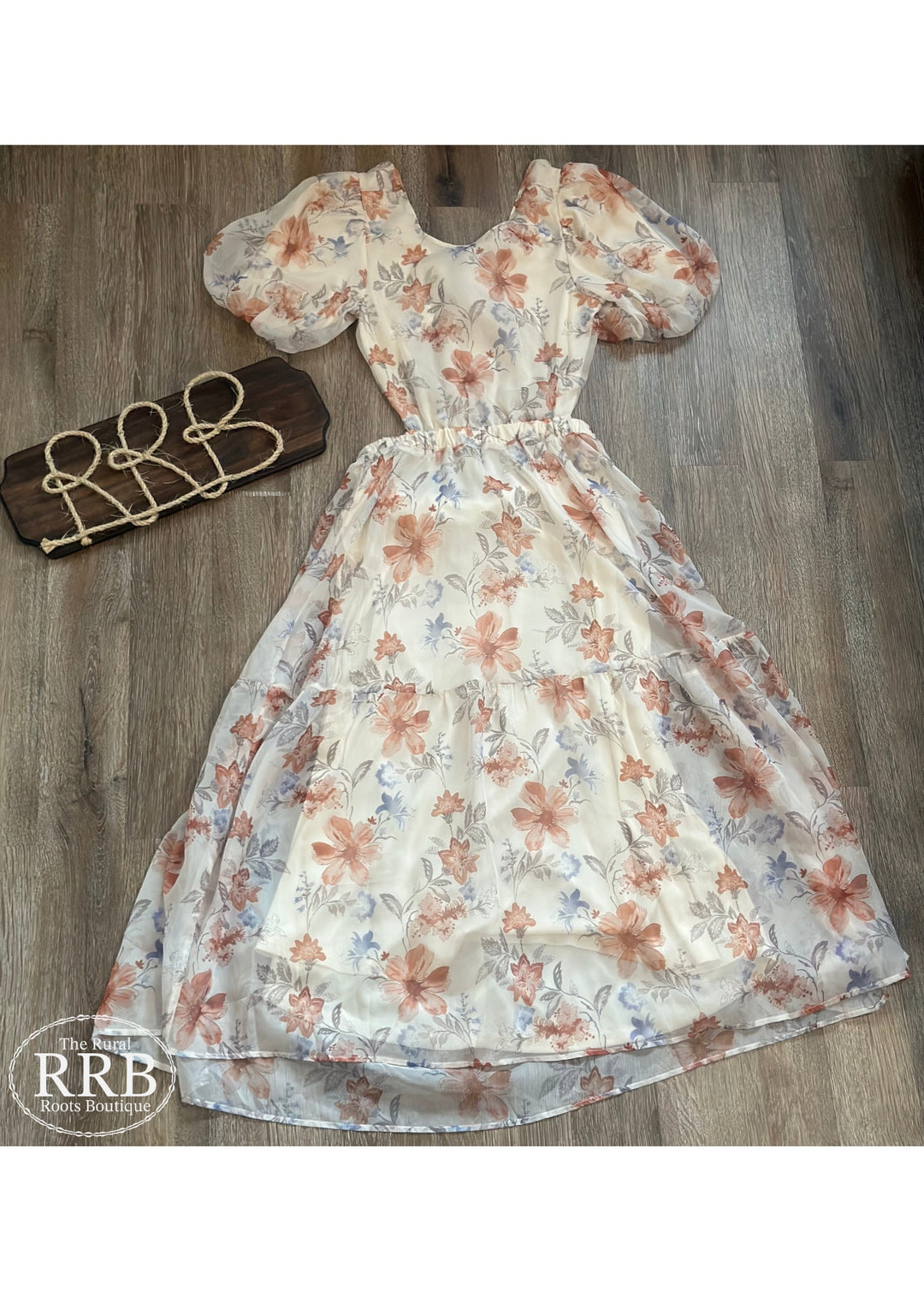 Embrace effortless elegance with The Little Prairie Dress, an ivory midi dress featuring charming puff sleeves and a stylish tie back. The open back design adds a touch of allure, making it perfect for any occasion. Made from 100% polyester, this dress is available in Small (3-5), Medium (6-8), and Large (9-11).