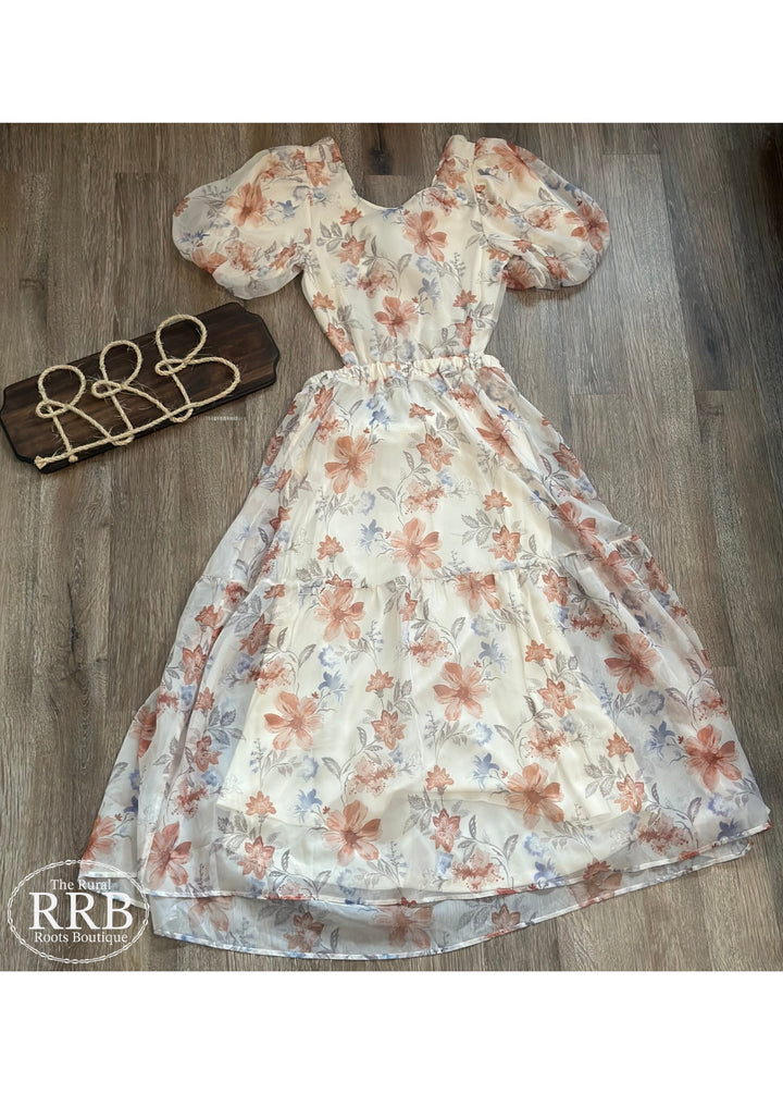 Embrace effortless elegance with The Little Prairie Dress, an ivory midi dress featuring charming puff sleeves and a stylish tie back. The open back design adds a touch of allure, making it perfect for any occasion. Made from 100% polyester, this dress is available in Small (3-5), Medium (6-8), and Large (9-11).