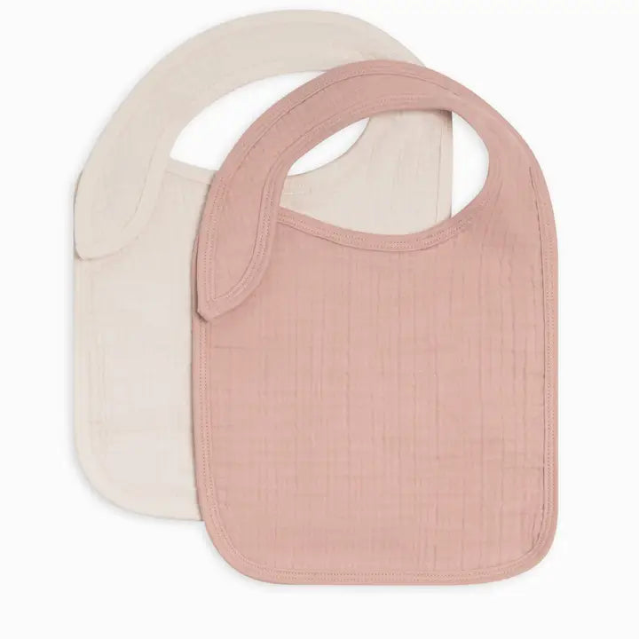 Classic 2 pack organic muslin baby bibs in soft ballet pink and ivory made from breathable absorbent cotton perfect for feeding drooling or teething gentle on baby skin and easy to wash ideal baby essential or gift for new moms and newborns.