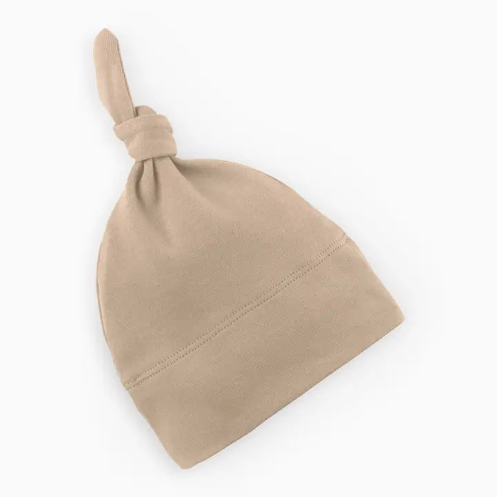 Classic knotted baby hat in clay made from soft breathable organic cotton gentle on newborn and infant skin perfect for everyday wear naps outings or photo shoots a cozy stylish essential for babies and a thoughtful gift for new moms.