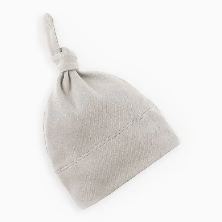 Classic knotted baby hat in stone color made from soft breathable organic cotton gentle on newborn and infant skin perfect for daily wear naps outings or photo sessions a cozy and stylish baby essential that makes a thoughtful gift for new moms.