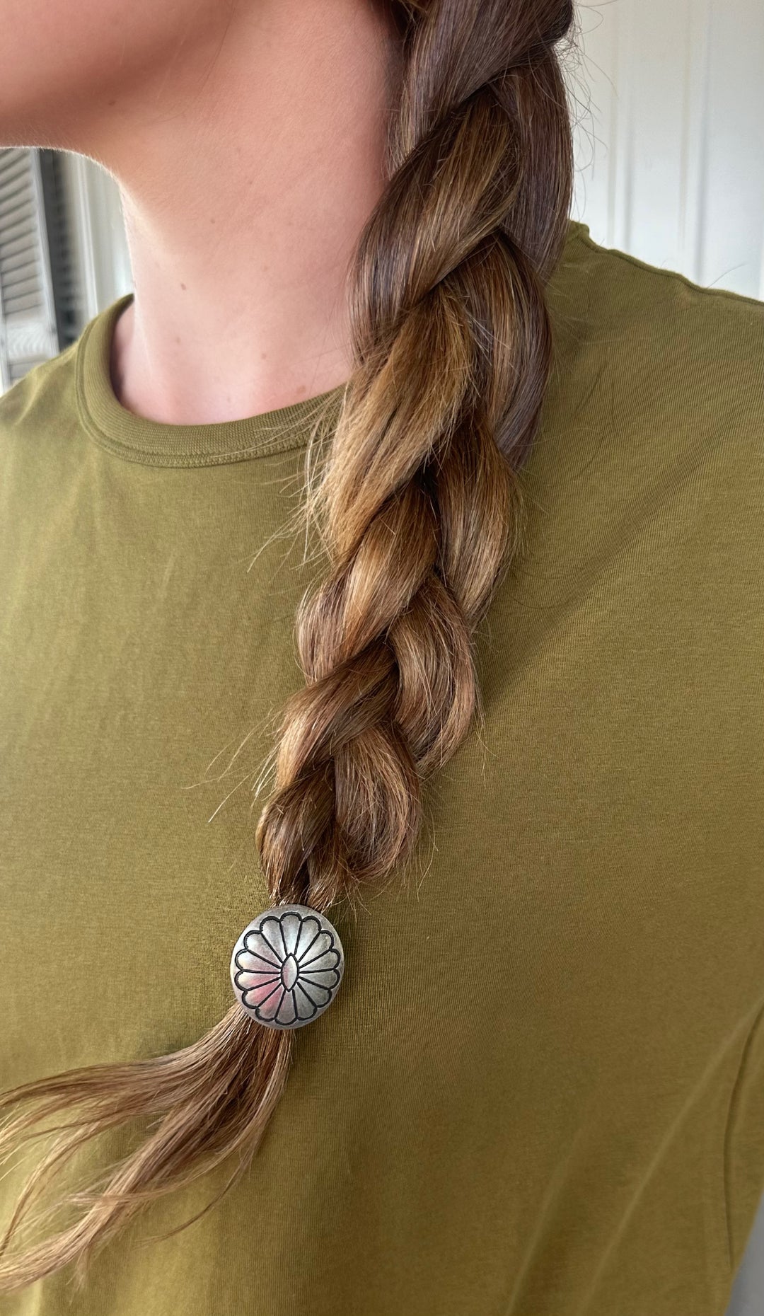 Elevate your hair game with the Concho Hair Tie, proudly made in the USA. This elegant hair accessory combines a classic concho design with practicality, suitable for all hair types. Perfect for everyday wear or special occasions, it adds a stylish touch to any outfit.