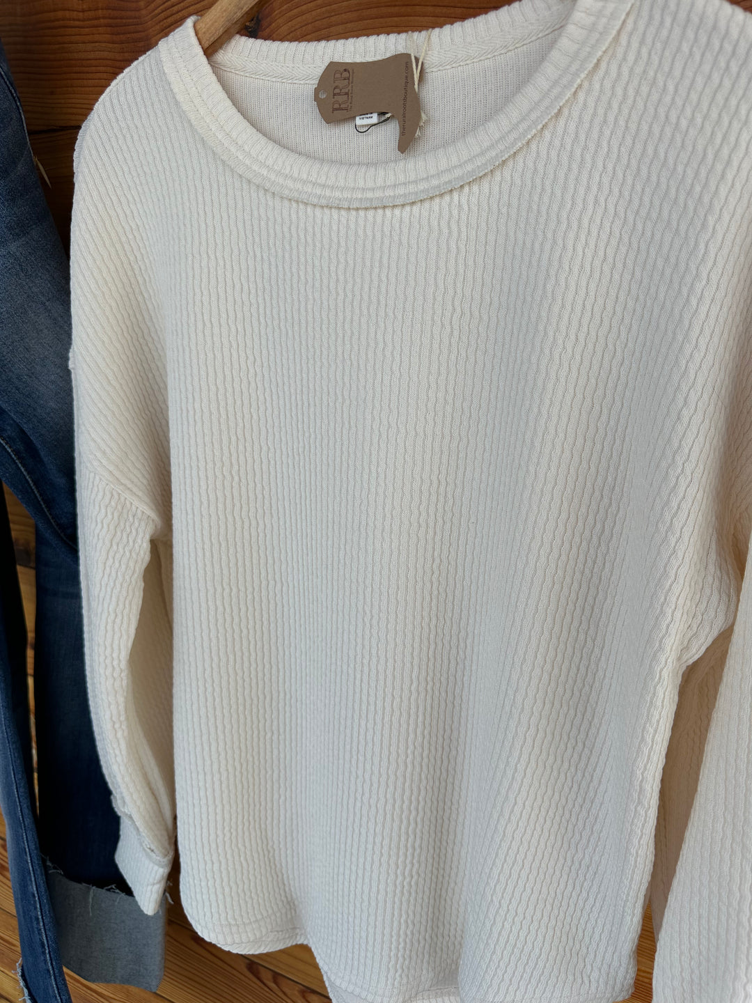 Discover The Crofton Sweater Knit Top in oatmeal, featuring a chic round neckline and long sleeves. Crafted from a luxurious blend of 87% polyester, 9% rayon, and 4% spandex, this relaxed-fit top is perfect for casual outings or cozy nights in. Elevate your fashion game today!