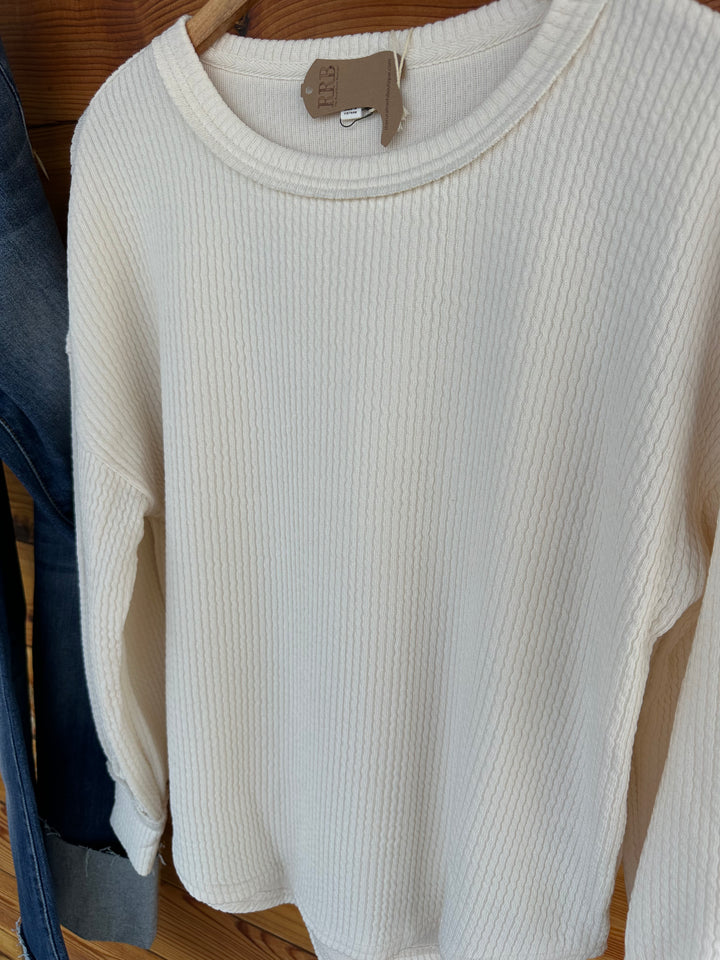 Discover The Crofton Sweater Knit Top in oatmeal, featuring a chic round neckline and long sleeves. Crafted from a luxurious blend of 87% polyester, 9% rayon, and 4% spandex, this relaxed-fit top is perfect for casual outings or cozy nights in. Elevate your fashion game today!