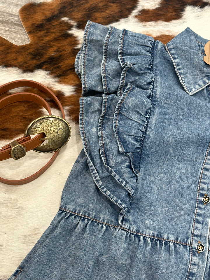 Trendy denim babydoll dress featuring a collared neckline, button-up closure, and layered ruffle shoulder detail. Lightweight and non-sheer with a relaxed fit, plus side pockets for convenience. Available in Small (3-5), Medium (6-8), and Large (8-11). Versatile style similar to pieces from American Eagle and Urban Outfitters