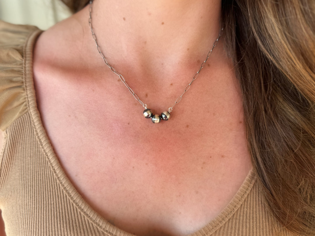 Embrace timeless elegance with The Everyday Navajo necklace, featuring 8mm Navajo pearls strung on a 16-inch silver chain. Complete with a secure silver lobster claw clasp, this stunning piece is proudly made in the USA, making it a perfect addition to any jewelry collection.