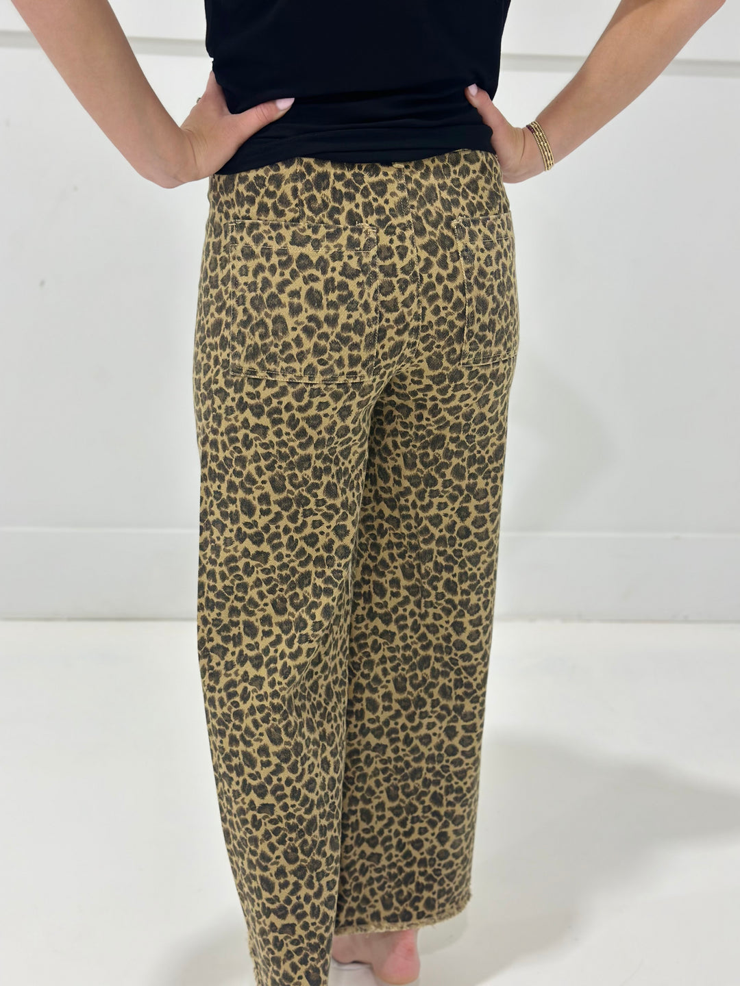 Bring the wild side out with these leopard print mid rise twill denim pants, featuring a relaxed wide leg and edgy frayed hem. The hidden button detail keeps the look clean while the unique pattern adds personality to your wardrobe staples.

