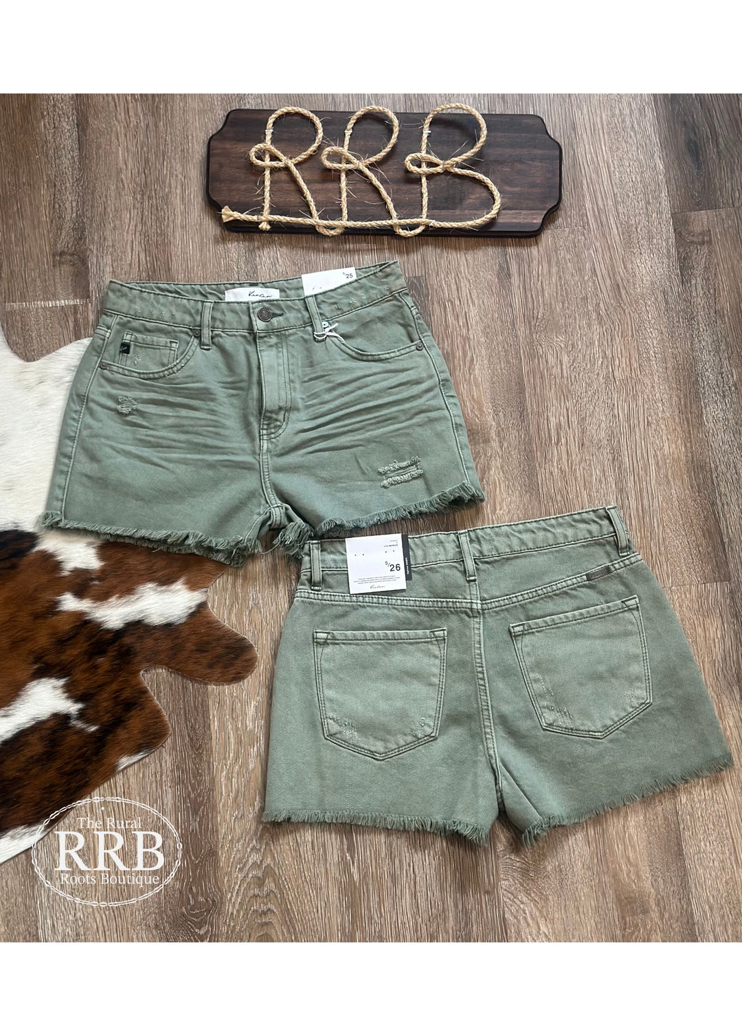Elevate your summer wardrobe with The Emerald Shorts in olive. These high-rise denim shorts feature a trendy frayed hem, a zipper fly for easy wear, and a rise of 10¾” with a 2½” inseam based on a size 5/26. Perfect for pairing with your favorite tops for a chic, casual look.
