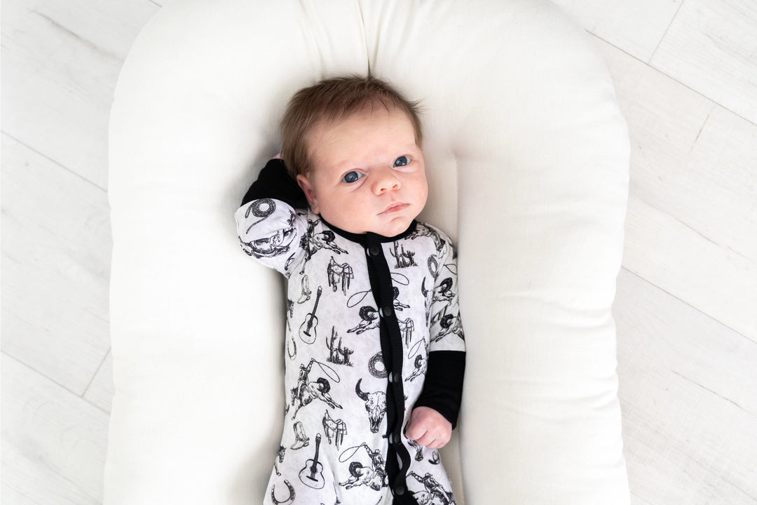 Hunter bamboo footie baby sleeper in black and white featuring western design details made from soft eco-friendly bamboo fabric gentle on newborn and infant skin perfect for sleep, play, or everyday wear durable, breathable, and a stylish baby clothing essential for boys and girls.
