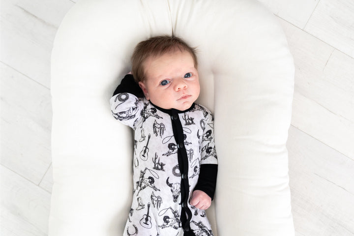 Hunter bamboo footie baby sleeper in black and white featuring western design details made from soft eco-friendly bamboo fabric gentle on newborn and infant skin perfect for sleep, play, or everyday wear durable, breathable, and a stylish baby clothing essential for boys and girls.
