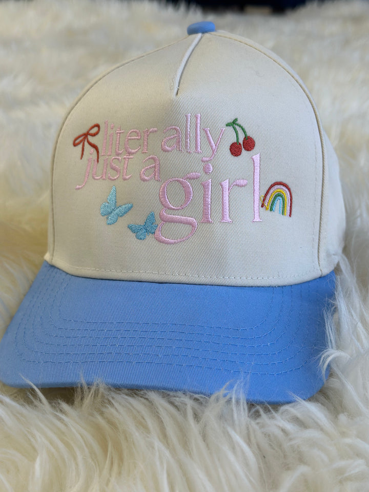 This Literally Just A Girl embroidered cap blends style and comfort with a blue and natural canvas design and an adjustable snapback closure for a perfect fit.