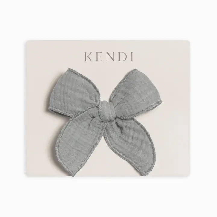 Neutral mist muslin bow hair clip for toddlers and young girls crafted from soft lightweight breathable fabric gentle on hair ideal for daily wear, parties, or special occasions a practical and adorable baby hair accessory and a perfect gift for new moms.