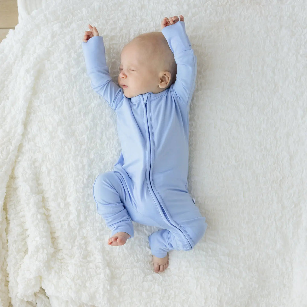 18 blue bamboo footie baby sleeper with convenient zip up design made from soft stretchy bamboo fabric gentle on newborn and infant skin ideal for naps, bedtime, or everyday wear lightweight, breathable, and a must-have practical baby clothing essential for boys and girls.