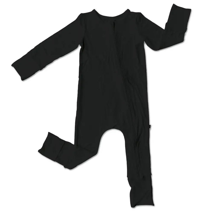 Organic bamboo footed sleeper in black with white feet crafted from sustainable bamboo viscose that is soft stretchy and breathable perfect for eco conscious parents and stylish enough for baby girls or boys to wear day or night.