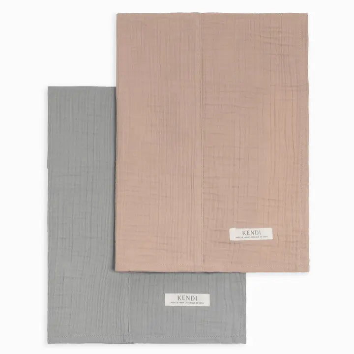 Two pack organic muslin baby burp cloths in mist and clay colors made from soft absorbent cotton gentle on newborn and infant skin perfect for feeding drooling and teething durable easy to wash and an essential practical accessory for new moms and babies.