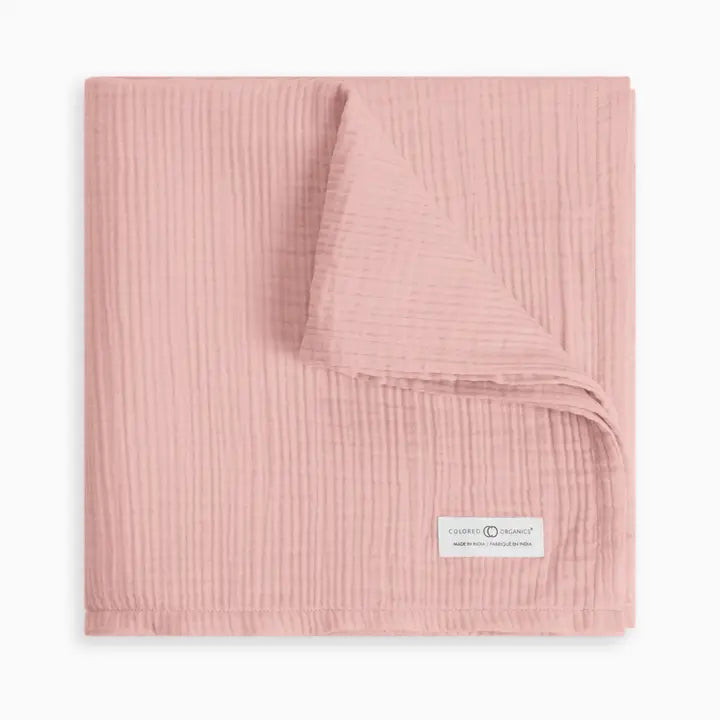 Organic muslin baby swaddle blanket in ballet pink crafted from soft absorbent cotton gentle on sensitive newborn and infant skin ideal for swaddling, cuddling, or stroller use lightweight, breathable, durable, and a must have practical baby essential for new moms.