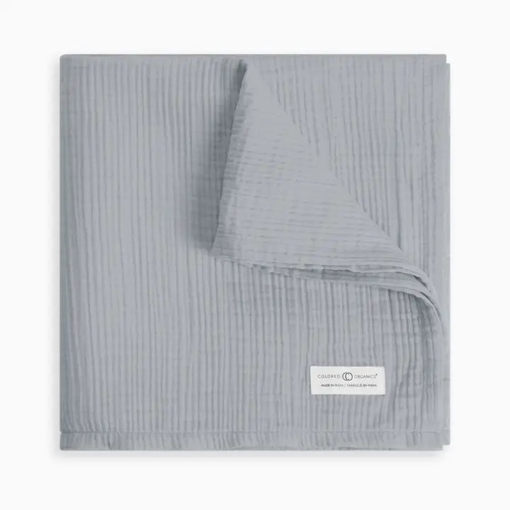 Organic muslin baby swaddle blanket in mist neutral shade crafted from soft absorbent cotton gentle on newborn and infant skin ideal for swaddling cuddling or stroller use lightweight, breathable, and durable a must have practical and stylish baby essential for new moms.