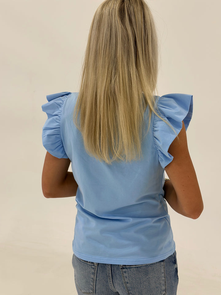 The Jewel is a bold and stylish sapphire blue fitted top designed to be the centerpiece of any outfit. Crafted from a premium stretch-knit fabric, this women’s boutique top offers a soft, buttery feel with just the right amount of structure for a flattering, body-hugging fit. Whether you’re looking for a statement piece to pair with skinny jeans and boots or a layering essential for business casual looks, this versatile top does it all. The Jewel is a must-have for trendsetters and fashion lovers looking fo