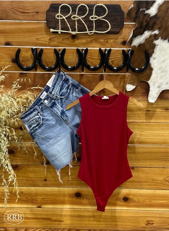 Elevate your wardrobe with The Lincoln Shirt, a red sleeveless bodysuit crafted from stretchy ribbed fabric. Featuring a double snap closure, this bodysuit offers a fitted yet comfortable fit. Made from 92% rayon and 8% spandex, it provides a flattering silhouette. If you prefer a slightly more relaxed fit, consider sizing up. Available in Small (3-5), Medium (6-8), and Large (9-11).