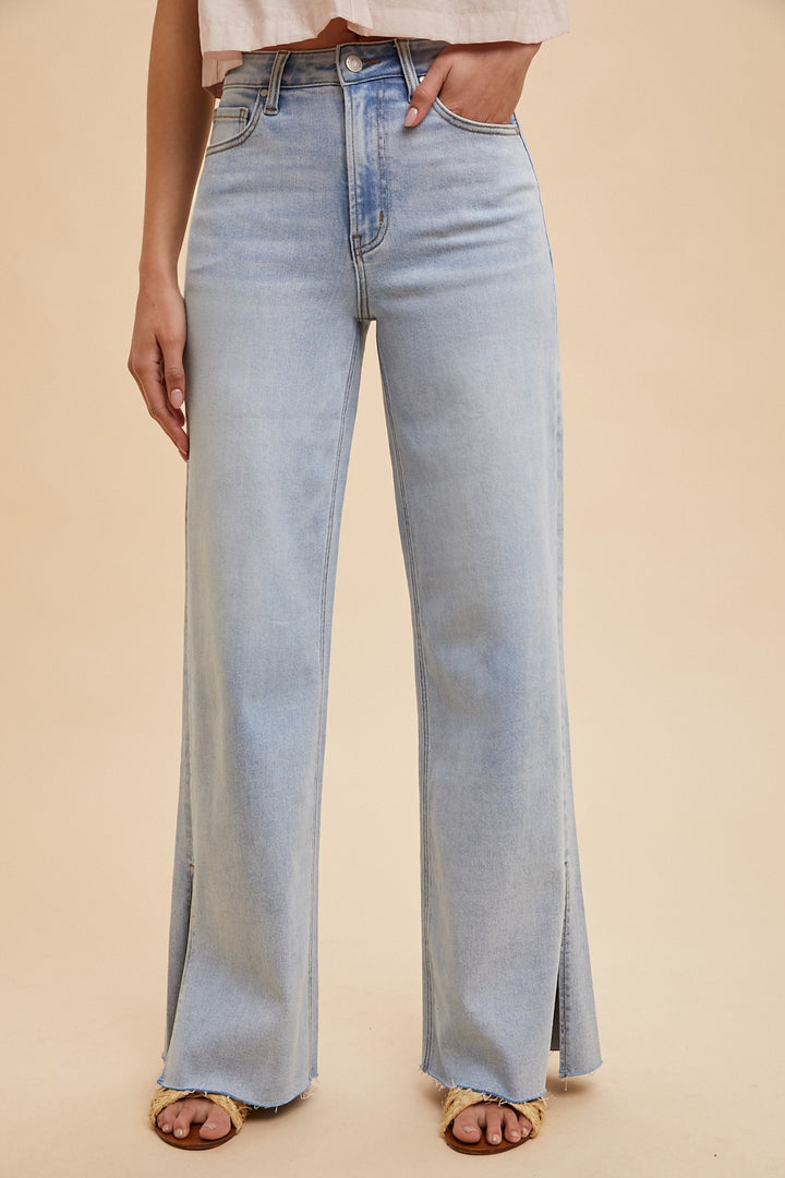 The Sadie High Rise Wide Leg Jeans feature a light wash and a flattering silhouette with a modern wide leg cut. Designed with subtle side slits at the hem, these jeans offer both style and comfort thanks to their stretchy denim blend of 92% cotton, 6% polyester, and 2% spandex. The high rise waistline provides a secure, contoured fit, making them a versatile staple for any casual or dressed-up look.
