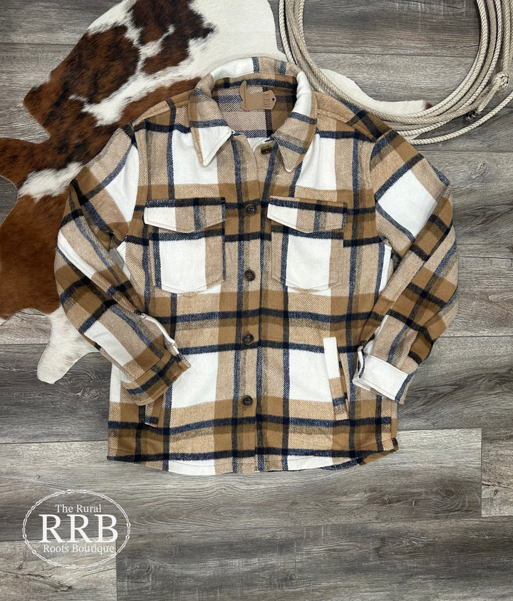 The Athens Camel Plaid Flannel Jacket features a relaxed, oversized fit with classic details, including a collared neckline, chest flap pockets, and convenient side pockets. Crafted from cozy flannel fabric, this jacket is perfect for layering on cooler days. Available in sizes small (3-5), medium (6-8), and large (9-11); if between sizes, sizing down is recommended. Comparable to shackets by Carhartt and Abercrombie, this jacket combines rugged style with warmth and comfort for everyday wear.