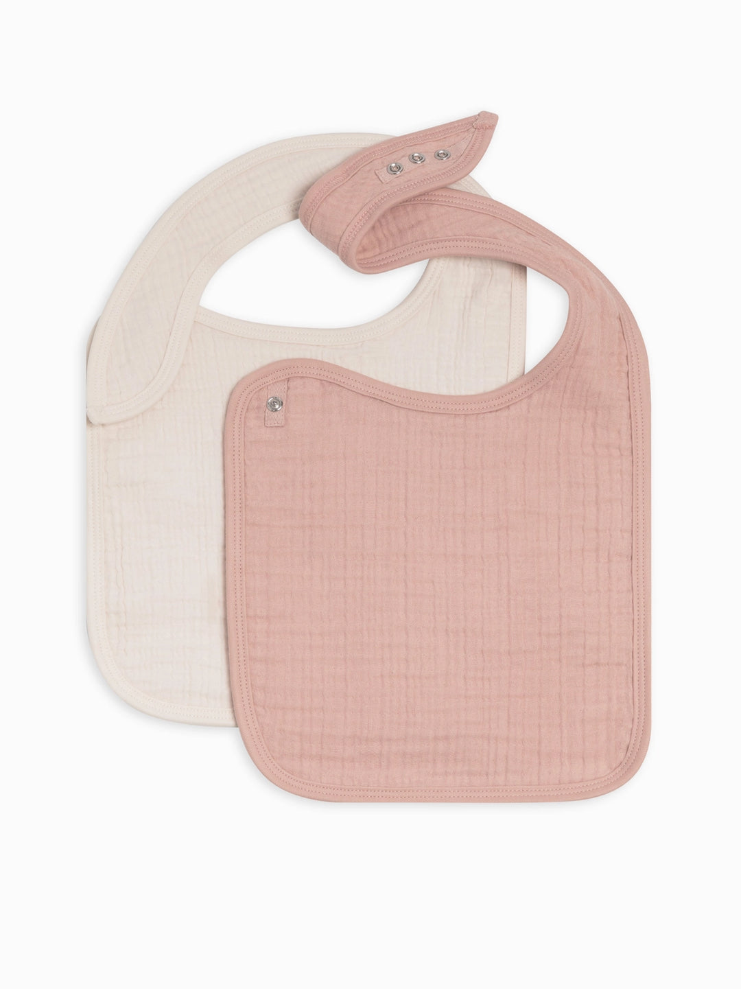 Two pack muslin baby bib set in ballet pink and ivory crafted from premium organic cotton muslin lightweight soft and durable for everyday feeding and drooling a must have for moms seeking neutral baby accessories that blend style and comfort.
