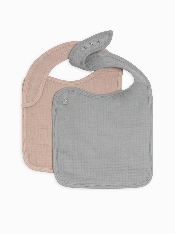 Two pack muslin baby bib set in mist and clay colors crafted from premium organic cotton muslin soft lightweight and absorbent perfect for feeding time drooling and teething practical and stylish baby accessory for everyday use.