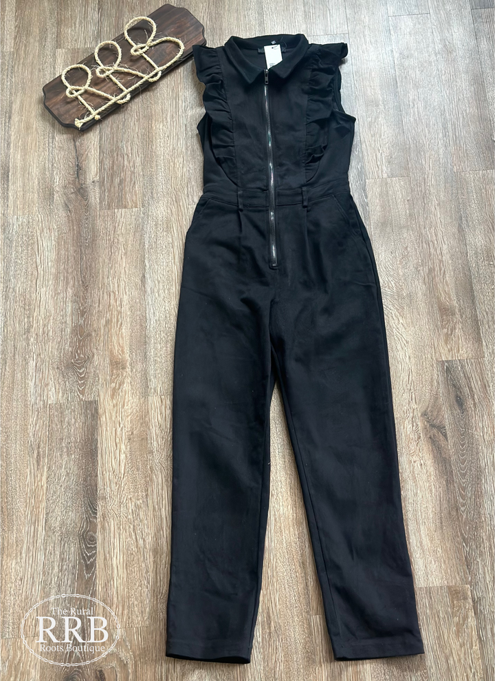 Elevate your wardrobe with The Cody Black jumpsuit, featuring a trendy ruffle zip-up design. Made from stretch twill fabric, this sleeveless jumpsuit includes a zip closure, ruffle detail at the front and back, an elastic waist, belt loops, and a spread collar. Available in small, medium, and large sizes, perfect for any occasion.