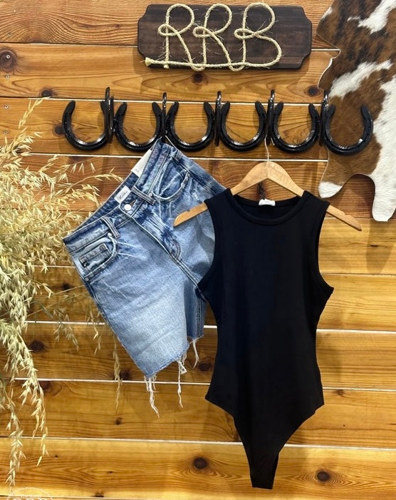 Discover The Dalhart Black Sleeveless Bodysuit, crafted from stretchy ribbed fabric for a fitted yet comfortable silhouette. Featuring a convenient double snap closure, this versatile bodysuit is perfect for layering or wearing solo. Made from 92% rayon and 8% spandex, it's designed for a snug fit, with the option to size up for a more relaxed style. A must-have for your wardrobe!