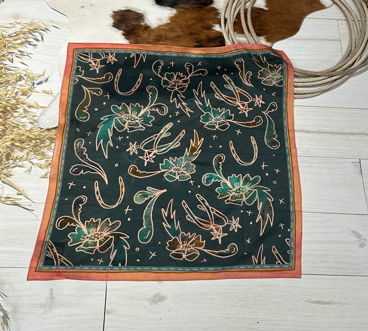 The Floral Wild Rag, a premium western wild rag made from 100% Mulberry silk, hand-drawn and designed. Versatile 35" x 35" accessory for bandanas, headbands, ponytails, and neck scarves.