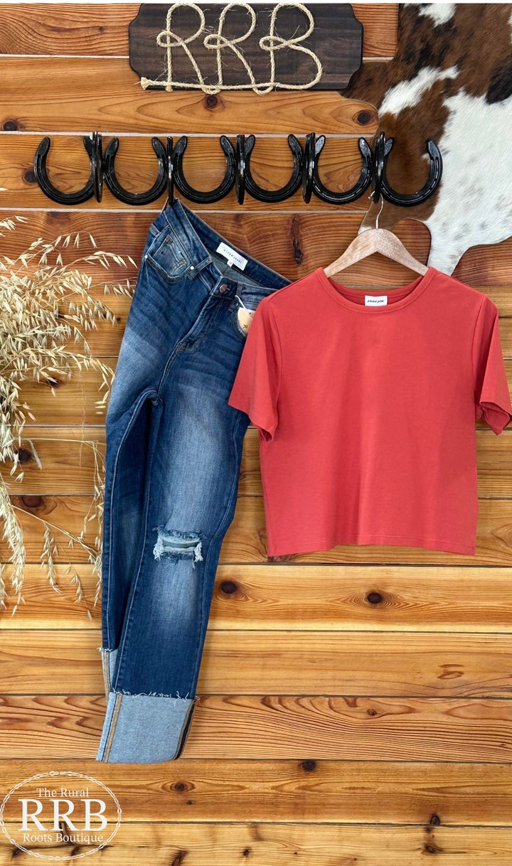 Embrace casual comfort with The Ginger Spice Mom Basic Crop Top. Featuring a boxy tee design in a warm Ginger Spice color, this top is crafted from 95% organic cotton and 5% spandex for a soft feel. Designed to run slightly smaller, we recommend sizing up if you're in between sizes. Available in sizes X-Small to X-Large.