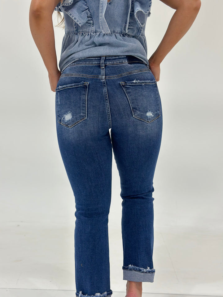 The Koby High Rise Straight Turn Up Jean offers a medium wash, distressed detailing, and a releaseable cuff for a customizable look. Made with a stretchy blend of 94% Cotton, 4% Polyester, and 2% Spandex.
