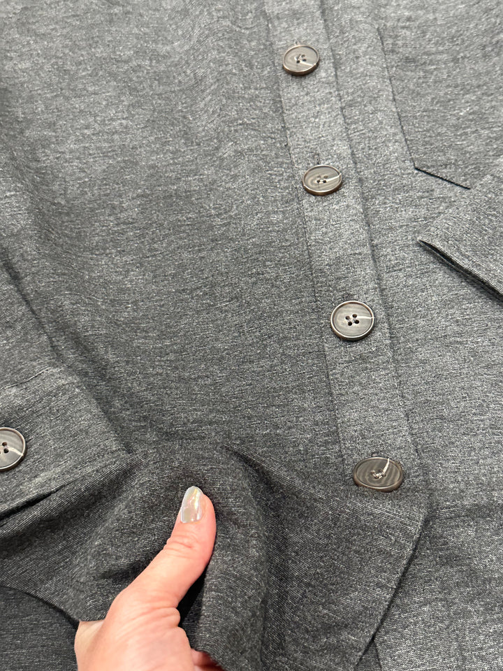 Trendy The Macon charcoal relaxed-fit shacket, featuring a button-down front, collared neckline, long sleeves, and single chest pocket. With a U-shaped hem and unlined construction, it’s perfect for layering. Made from a cozy blend of 87% polyester, 9% rayon, and 4% spandex, available in Small (3-5), Medium (6-8), and Large (9-11). A versatile wardrobe staple similar to popular shackets from Anthropologie and Madewell.