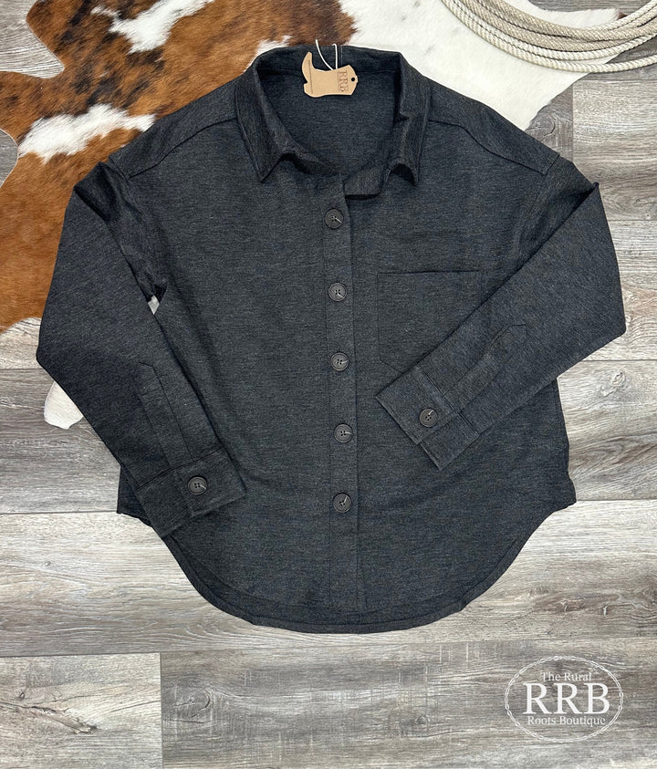 Casual and stylish The Macon charcoal shacket with a relaxed fit, featuring a collared neckline, long sleeves, and button-down design. This versatile shacket has a single chest pocket, U-shaped hem, and is crafted from a soft blend of 87% polyester, 9% rayon, and 4% spandex. Available in sizes Small (3-5), Medium (6-8), and Large (9-11). A perfect layer for any season, comparable to shackets from Free People and Urban Outfitters.