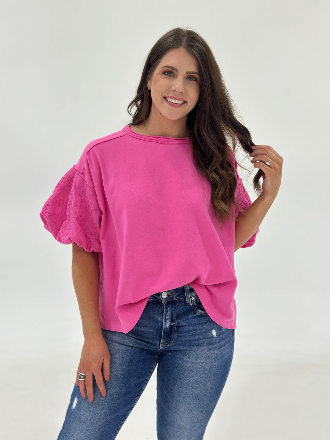 The Marren in Candy Pink is a women’s short sleeve top designed with a classic round neckline, soft bubble sleeves, and contrast fabric details that elevate its sweet, feminine charm. Crafted from 100% cotton, this blouse features a lightweight, breathable woven texture and a relaxed flowy fit that flatters a range of body types. The silhouette is airy yet polished—ideal for spring and summer outfits or layering year-round. If you're between sizes, we recommend sizing down for the best shape and structure. 
