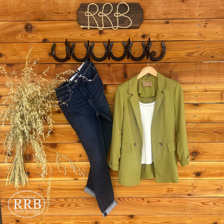 Polished and versatile, The Memphis blazer in kiwi green features a collared neckline, 3/4 cuff sleeves, notch collar, and structured shoulder pads. With a button-front closure and tabbed pockets, this lightweight, unlined blazer is crafted from a blend of 40% polyester, 30% rayon, 20% cotton, and 10% linen. Available in sizes Small (3-5), Medium (6-8), and Large (9-11), and pairs effortlessly with The Casey High Rise Jean and The Lacey Top in cream. Comparable to blazers from Zara and Mango.