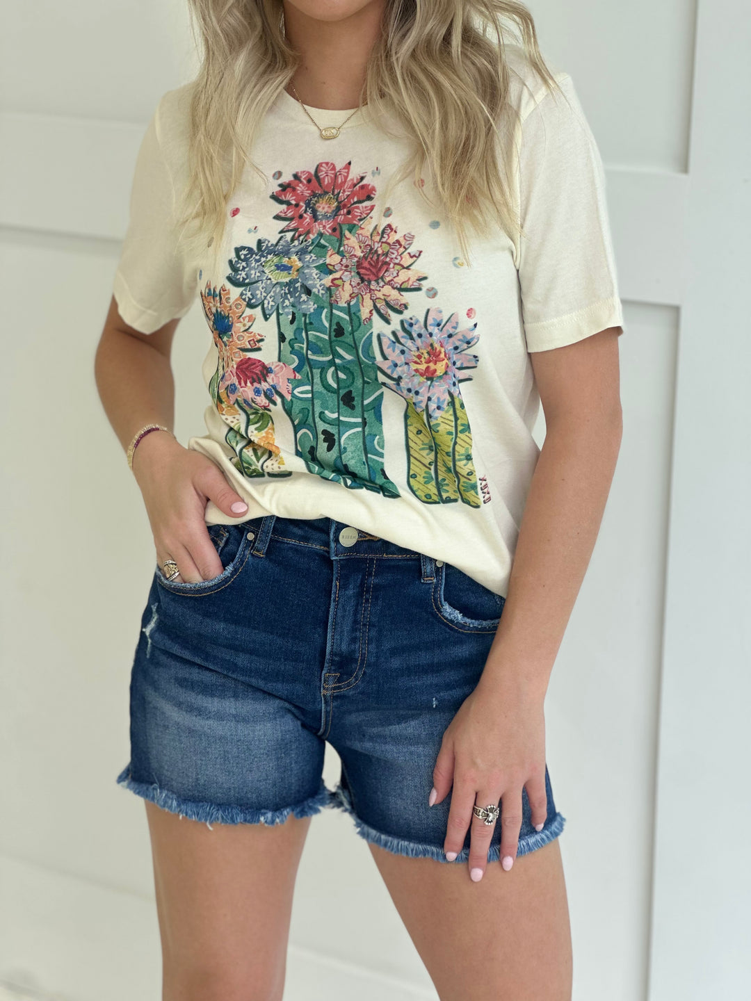 The Saguaro Graphic Tee in a natural cotton finish features a hand-drawn western design by XOXOart & Co., printed on a unisex fit for versatile styling. Crafted from 100% breathable cotton, this tee delivers comfort, character, and a little desert soul to your everyday look.