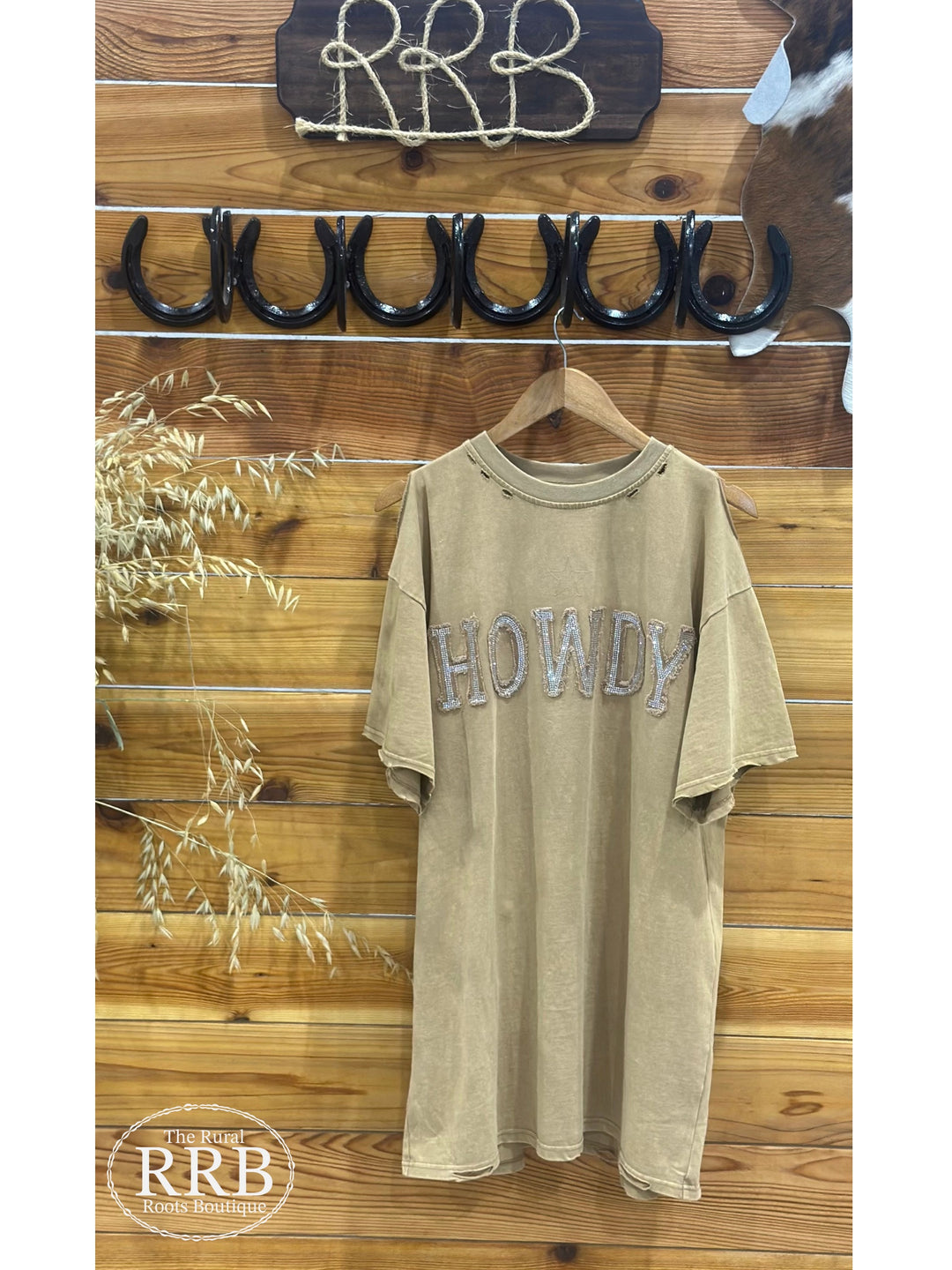 Step out in style with The ShineDown, a trendy tan t-shirt dress featuring an embellished stone graphic and unique star stitching. Designed with distressed shoulder edge details for a relaxed, laid-back look, this dress is crafted from 100% cotton for all-day comfort. Perfect for casual outings or layered for added flair.