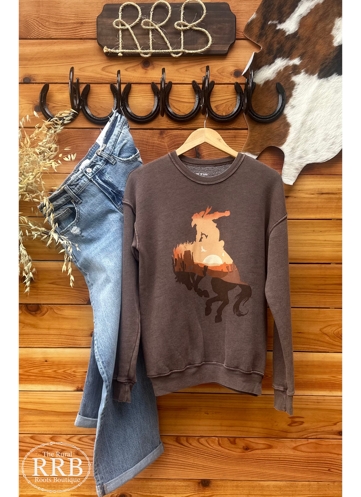 Embrace your inner cowboy with The Wild Cowboy Tee in mineral brown. This stylish shirt is perfect for a laid-back yet trendy look, available in sizes Small (3-5), Medium (6-8), Large (9-11), and X-Large (12-14). Pair it with your favorite jeans for a classic western vibe.