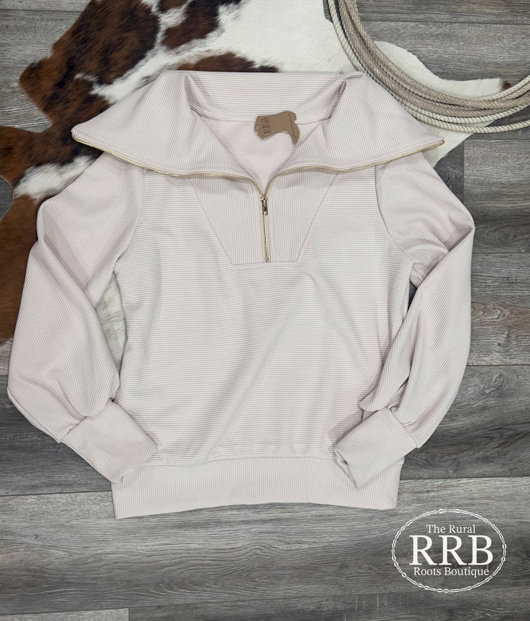 Discover The Winona cream pullover, featuring a chic collared design and a convenient front zipper. This relaxed-fit top is crafted from a soft blend of 95% polyester and 5% spandex, ensuring comfort and style. Available in Small, Medium, and Large sizes, it's perfect for layering or wearing on its own.