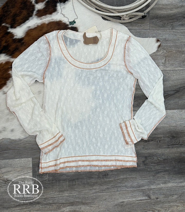 Upgrade your wardrobe with The Wood River shirt, a stunning white lace top featuring contrast stitch detailing. This long-sleeve design has a flattering scoop neck and is made from a comfortable blend of 90% polyester and 10% spandex. Available in Small, Medium, and Large sizes, it's perfect for any occasion.