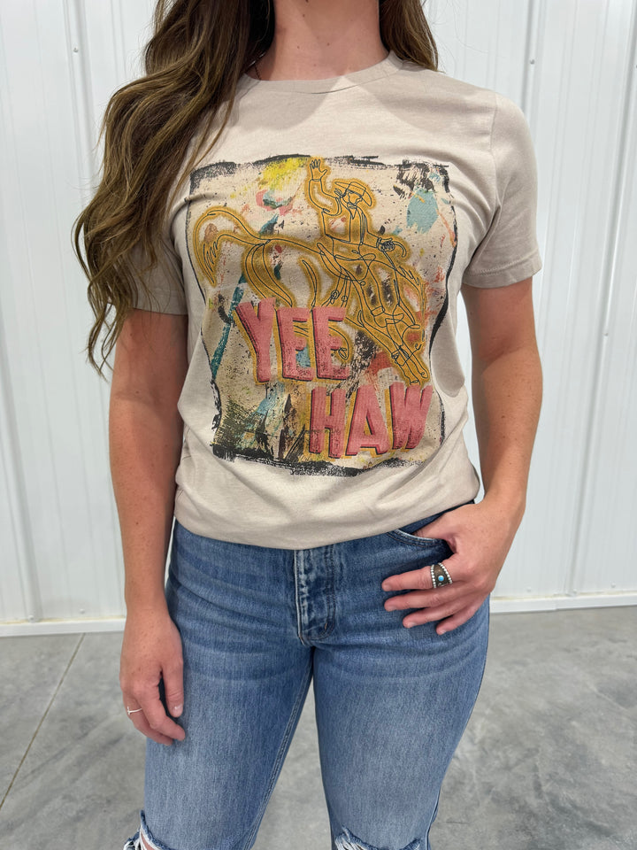 Get ready to make a statement with The Yeehaw Tee: Splatter Cowboy Edition in belle tan. This unisex fitting t-shirt combines a playful splatter design with a classic cowboy theme, perfect for casual wear or fun events. Offered in sizes X-Small (0-2), Small (3-5), Medium (6-8), Large (9-11), and X-Large (12-14), it’s a must-have for any western-themed wardrobe.