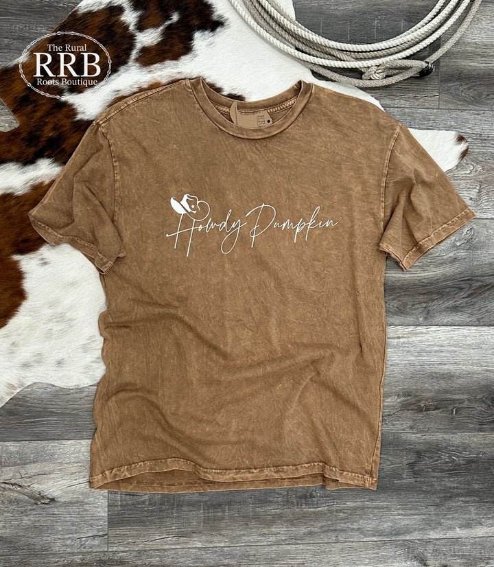 Embrace the season with the Howdy Pumpkin Shirt, crafted from 100% premium cotton jersey in a warm toast color. This relaxed fit unisex shirt is available in Small (3-5), Medium (6-8), Large (9-11), and X-Large (12-14), making it a must-have for pumpkin lovers!