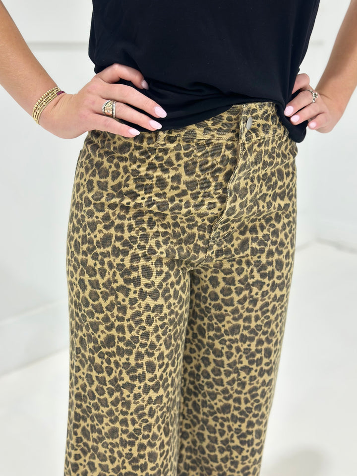 Step out in style with these leopard print mid rise twill denim pants, featuring a flattering wide leg silhouette and raw frayed hems. The hidden button closure keeps the look sleek while the bold leopard pattern adds a wild edge to your denim collection.

